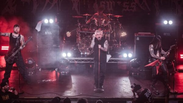 A Swiss live metal band performing on a brightly lit stage.